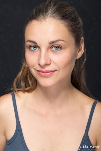 Melbourne Actor Headshot of blonde girl on a dark background. She has a slight smile.