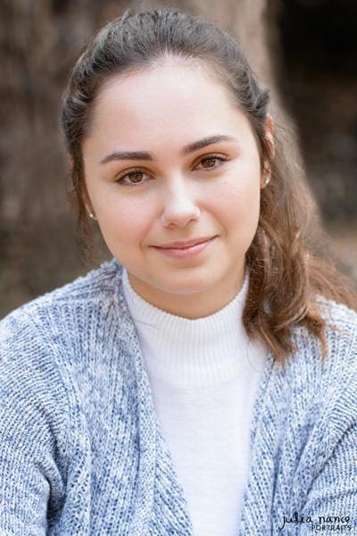 Brunette woman with small smile - natural light outdoor melbourne actor headshot