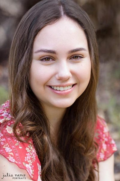 Brunette woman wearing red top smiling - melbourne actor headshot