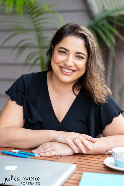 Melbourne personal branding portrait of woman sitting outside at table with cup of tea