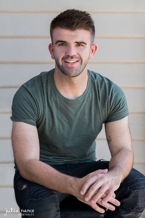 Male smiling at camera while sitting outdoors - melbourne personal branding photography and corporate headshots