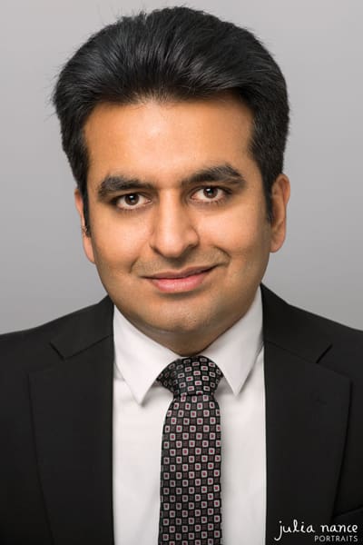 Melbourne headshot of man in studio wearing formal suit and smiling