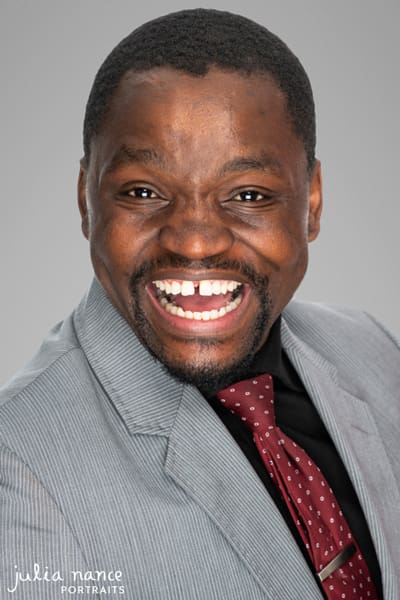 Professional Headshot of man smiling in grey suit. Melbourne Corporate Headshot Photography, LinkedIn headshot Photography, Personal Branding Photography.