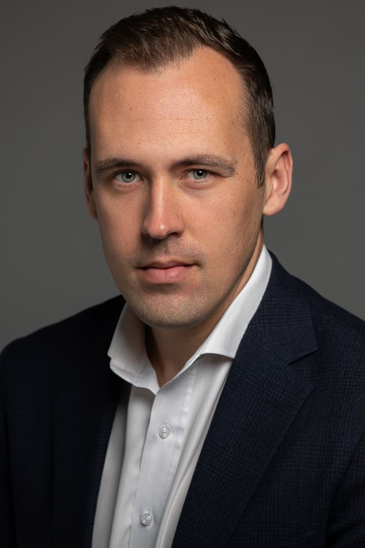 Corporate headshot of melbourne actor playing business character with serious expression.