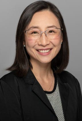 Melbourne woman smiles to camera for a confident and relaxed corporate headshot.
