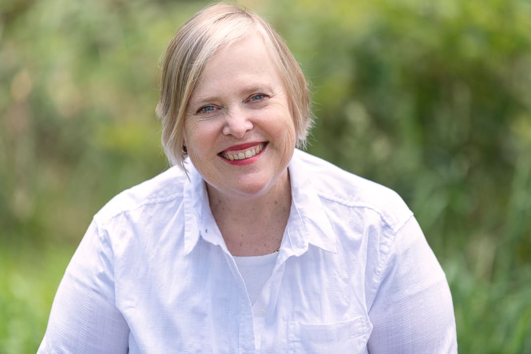 Melbourne business woman smiles to camera for relaxed outdoor corporate headshot