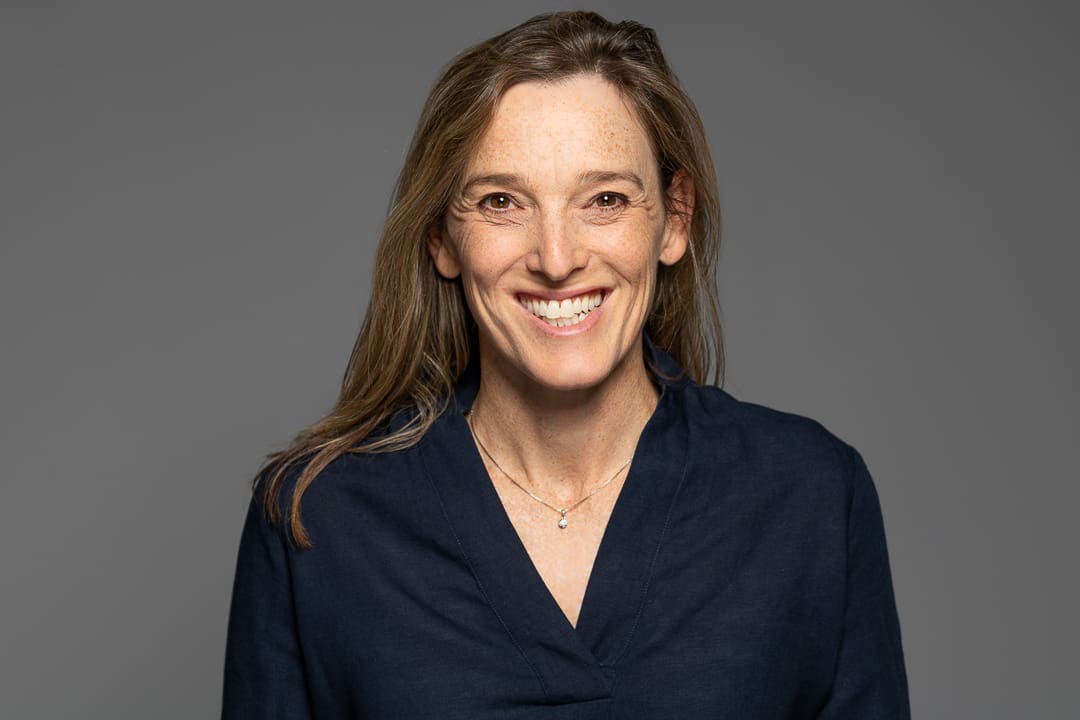 woman smiles to camera in corporate headshot taken in melbourne studio