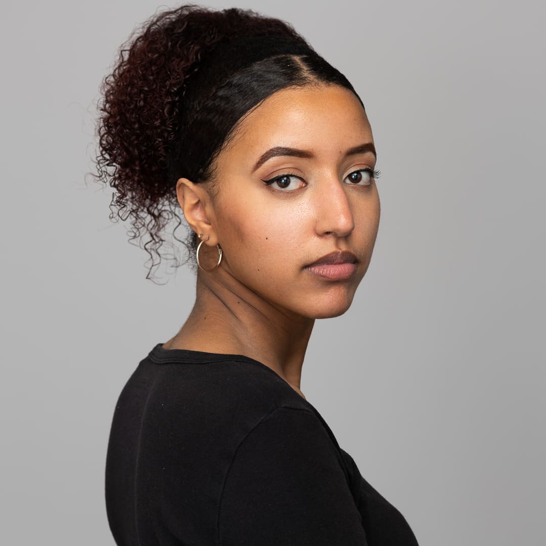 Melbourne actress looks to camera over her shoulder with serious and relaxed expression for headshot update.
