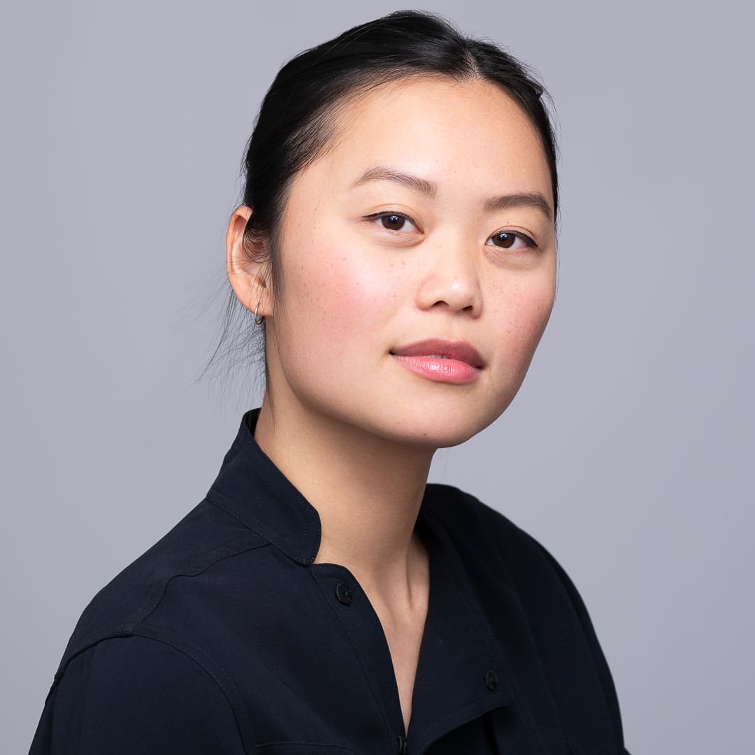 A woman poses for a calm actor headshot in a studio environment.