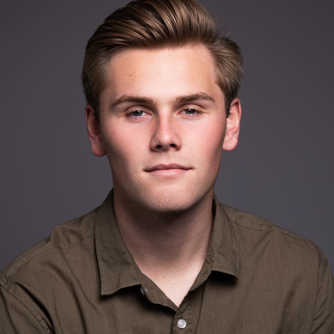 Actor headshot of man looking to camera with serious expression taken in studio