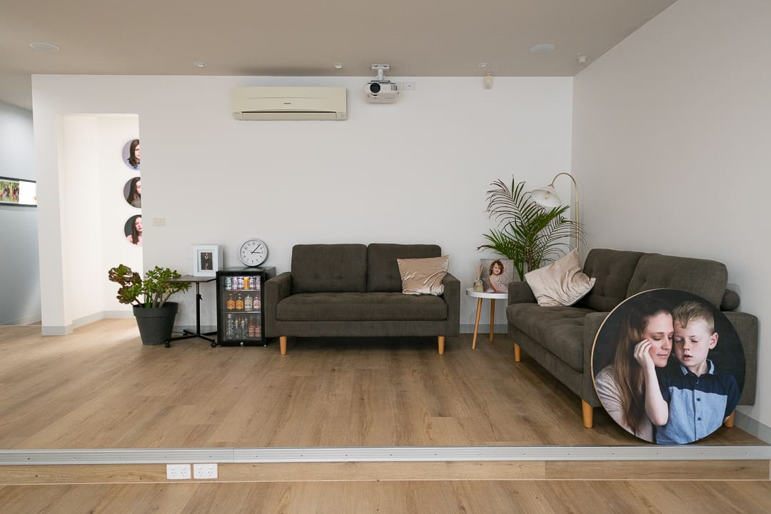 Interior image of the Julia Nance Portraits studio in Ringwood East. You can see couches and fridge.