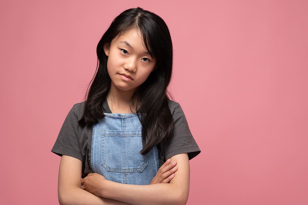 Teen actor in melbourne poses with arms crossed and a serious expression.