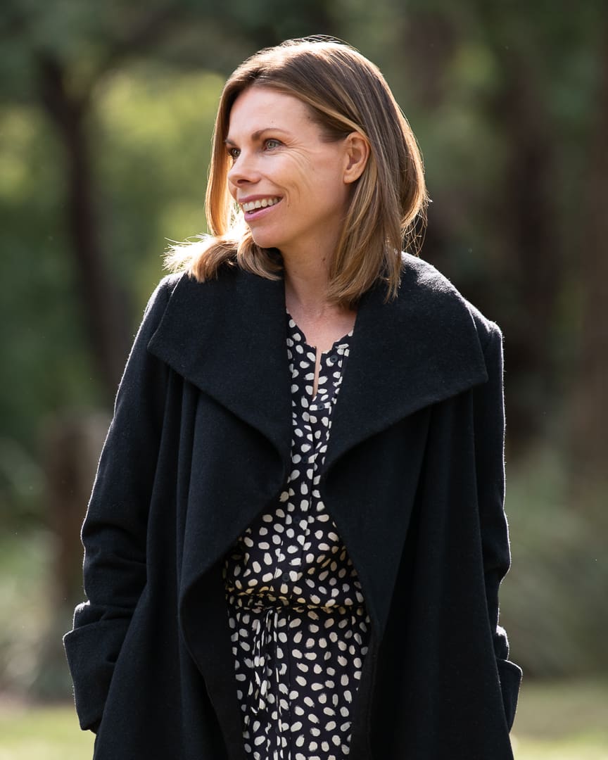 Melbourne author smiles and looks away from camera in headshot update.