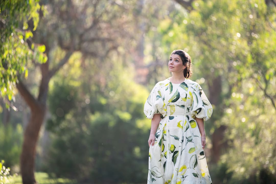 A candid branding portrait of a woman, who looks away from camera while walking outside in a natural outdoor setting in melbourne.