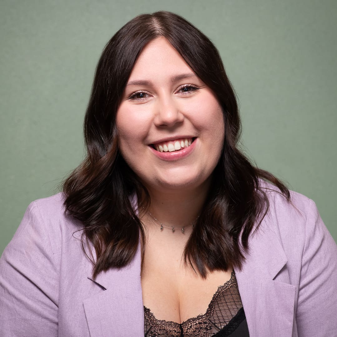 Melbourne business woman smiles to camera in colourful and relaxed studio headshot