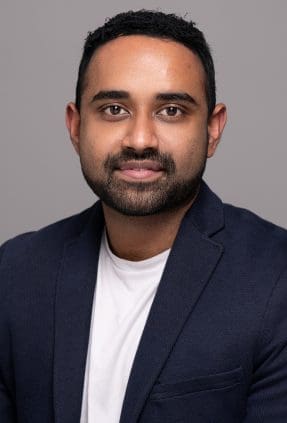 Corporate headshot of melbourne man taken on a grey background.