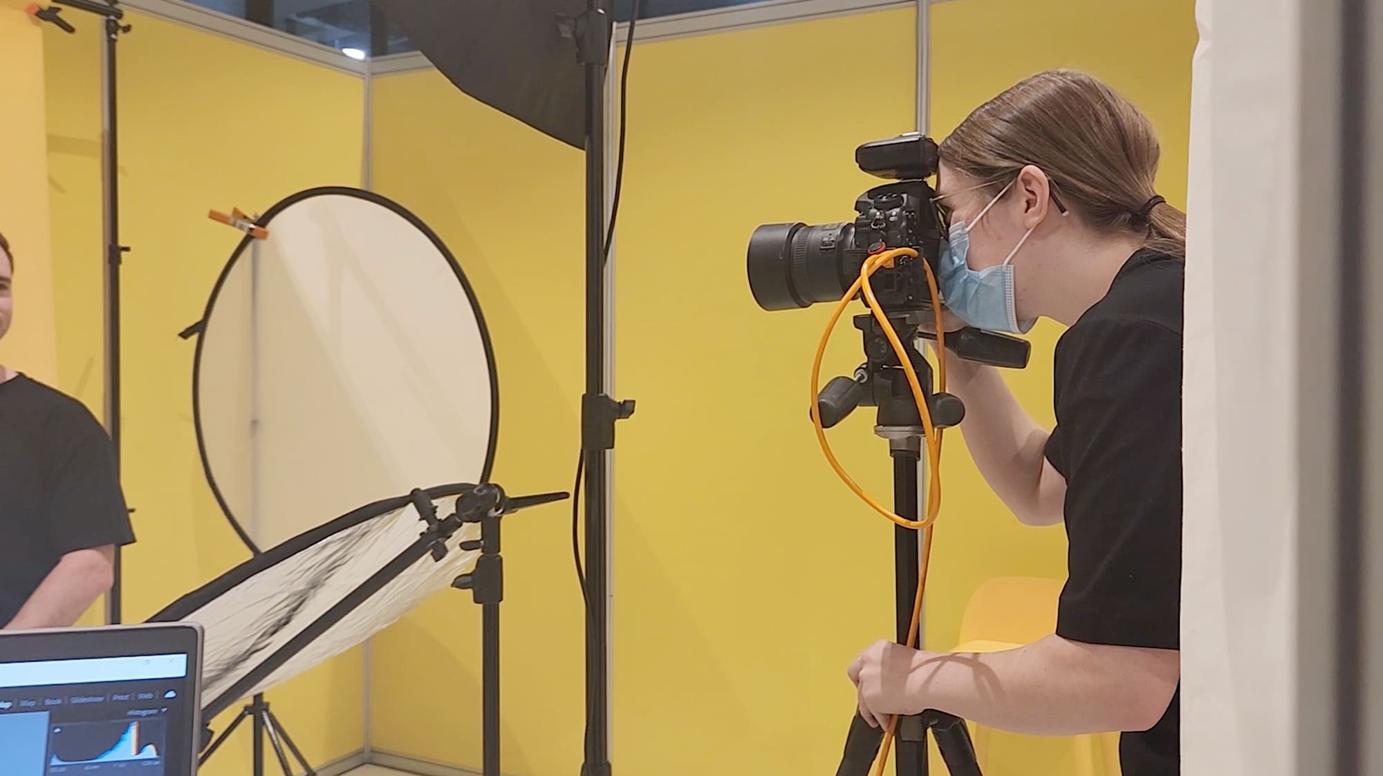 Behind the scenes image of Julia photographing at the small biz expo 2022