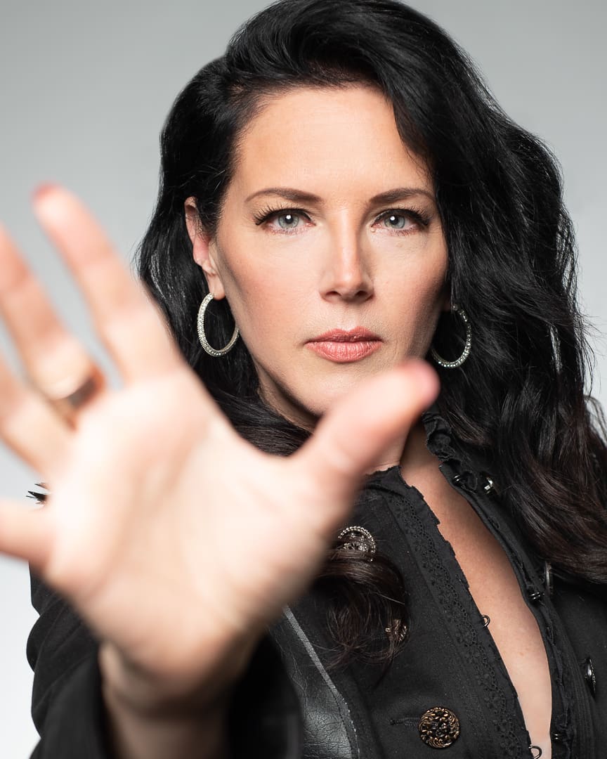 Personal branding headshot of Melbourne business owner with hand stretched out to camera.