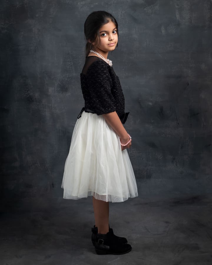 Young model stands in studio for a soft fine art portrait for her modelling portfolio photoshoot.