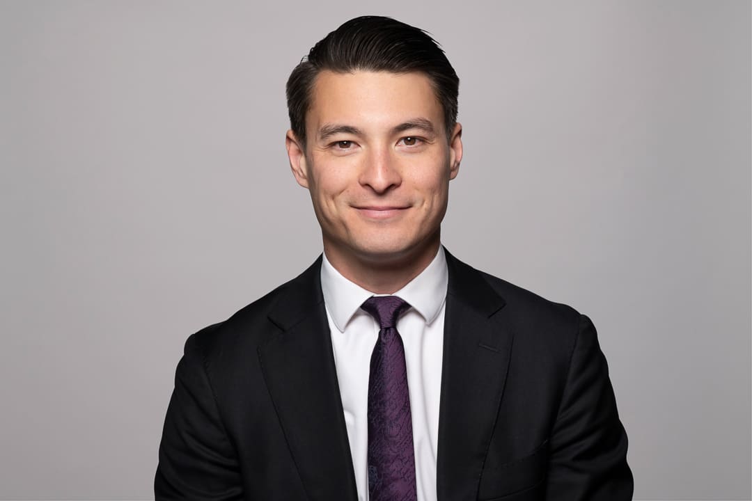 Melbourne barrister headshot of man smiling to camera wearing a suit and tie.