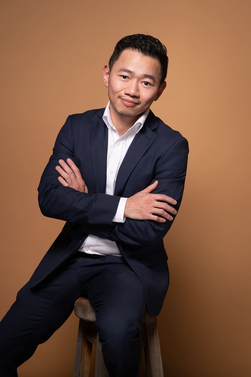 Professional business portrait of a Melbourne accountant, wearing a suit with his arms crossed.